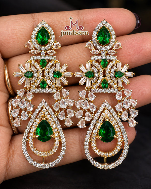 Hand-held image of Emerald Green and White Chandelier CZ (Zircon) American Diamond (AD) Statement Earrings provided to showcase the true statement scale and dimensions of the chandelier design.