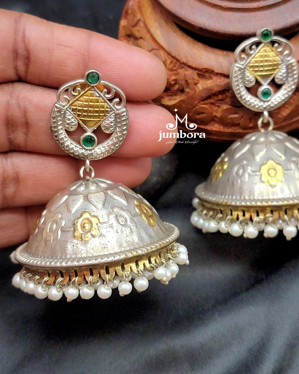 Silver Look Alike (SLA) Dual Tone Big Oxidized German Silver Jhumka Earring Held in model hand to show sizing and scaling
